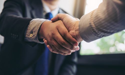 Two business men shaking hands during a meeting to sign agreement and become a business partner, enterprises, companies, confident, success dealing, contract between their firms